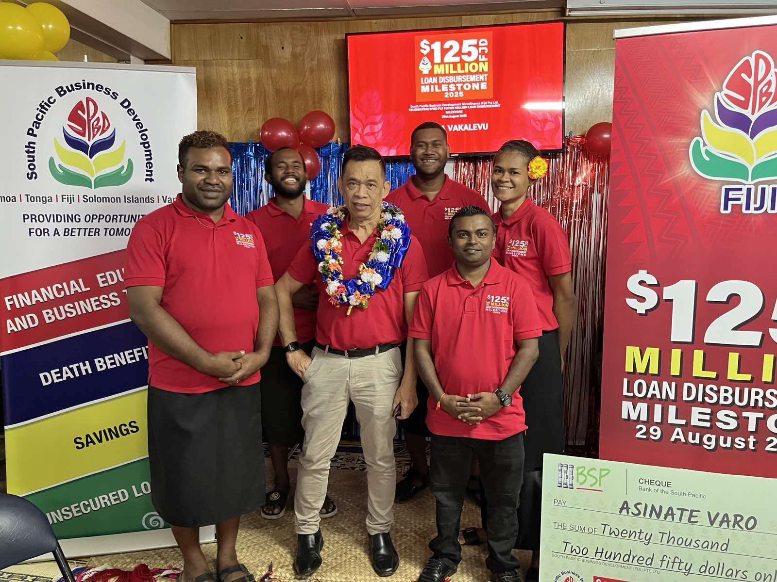 SPBD Fiji director and general manager Elrico Munoz (with garland) is flanked by staff during a special ceremony to celebrate SPBD Fiji’s milestone disbursement of $125m in micro loans.